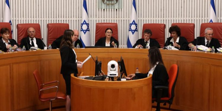 Israel’s top court strikes down key part of judicial overhaul, in ruling that could reignite divisions as war rages