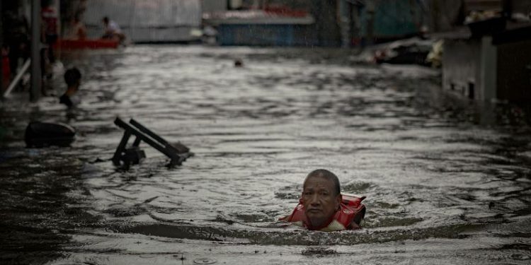 Thousands stranded by floods in Philippine capital as deadly typhoon prompts calls for climate action