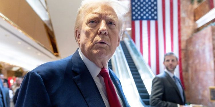 Now, Trump says, the photo of him with E. Jean Carroll may be ‘AI’