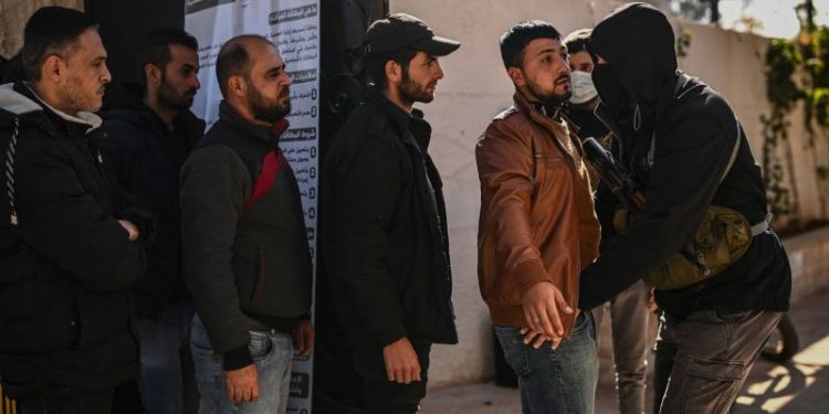 Former Assad security forces hand in weapons to new Syrian government