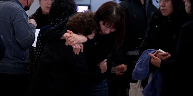 Sobbing and prayers echo through South Korean airport as families mourn air crash victims