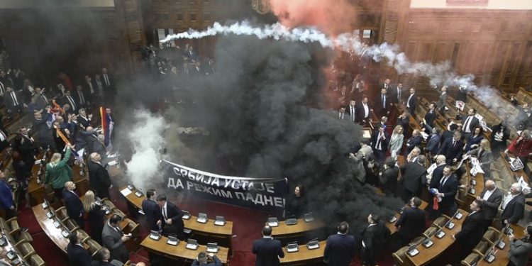 Smoke grenades tossed in Serbian parliament, lawmaker suffers stroke