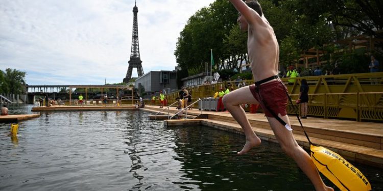 Joyful Parisians take a historic plunge into the Seine after 100 years